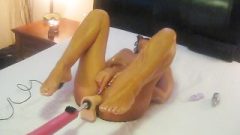 Arousing Tanned Wife Filmed Nailing Rubber Toy Machine